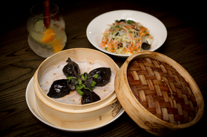 Steamed prawn, crap and squid ink dumpling with buddha salad side. Photo / Sarah Ivey