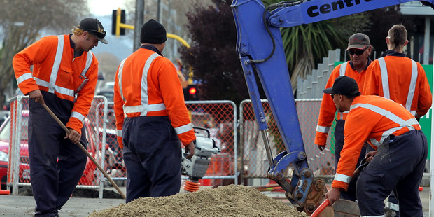 Workers installing fibre optic cable in Wanganui. Many argue that if copper and fibre prices are closely aligned users will be much more encouraged to move to the new network. Photo / Stuart Munro