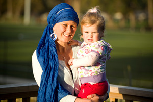 Emerald Reid (with daughter Summer, 2) has the same BRCA1 gene that led Angelina Jolie to have her breasts removed. Mrs Reid did the same. Photo / Michael Craig