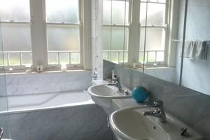 Simplicity in marble bathrooms with extensive use of mirror.