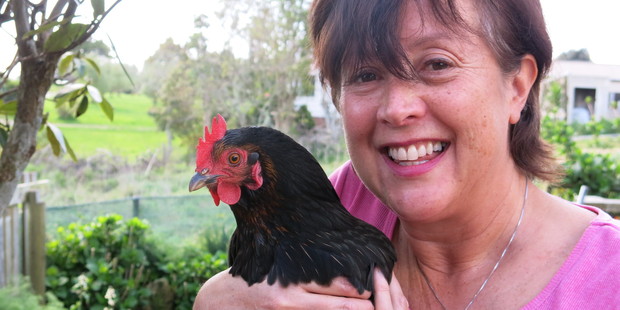 Kay Eagle with Ginger, the crowing hen which is developing spurs and behaving like a rooster.