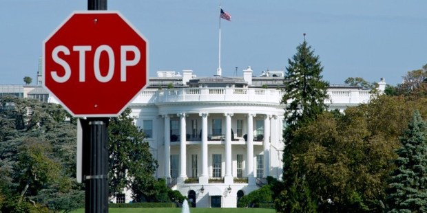 The White House is seen behind a stop sign in Washington, DC, as the federal shutdown began. Photo / AFP