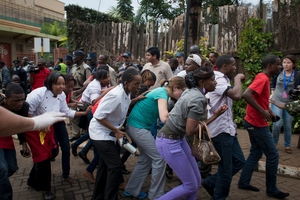 Shoppers and staff flee from the gun battle in an upmarket mall where more than 60 people died in a four-day siege. Photo / AP