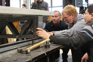 Charles Clifton (centre) shows the intricacies of the new flooring system, which is designed to minimise deaths and damage.