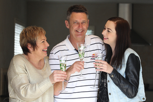 The re-elected mayor of Tauranga, Stuart Crosby, celebrates with his wife Lesley and daughter Jessica at their Papmoa Home.