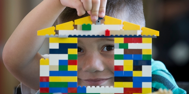 Caleb Waititi, 6, eyes his roofline during the Lego house building competition. Photo / Greg Bowker