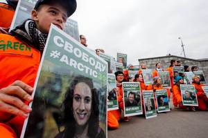 Greenpeace activists hold up portraits of the seized crew members of the ship Arctic Sunrise, in a rally in Moscow. Photo / AP
