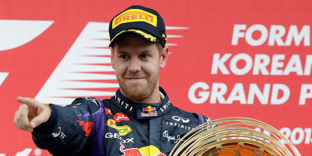 Red Bull driver Sebastian Vettel gestures as he celebrates on the podium after winning the Korean Formula One Grand Prix at the Korean International Circuit in Yeongam, South Korea. Photo/AP