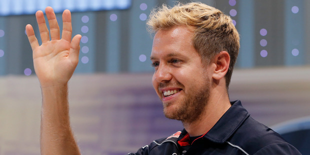 Red Bull driver Sebastian Vettel smiles and waves at his fans during an event at the Nissan Motor Co.'s global headquarters in Yokohama, Japan. Photo / AP