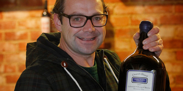 Mike Van de Elzen with a 6 litre bottle of Church Block wine. Photo / Christine Cornege