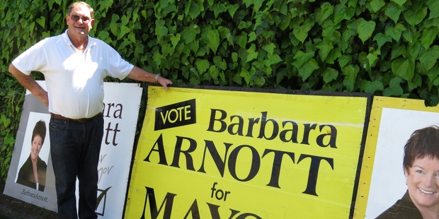 David Arnott, husband of retiring Napier Mayor Barbara Arnott, with signs he has placed during her election campaigns from 1995-2010. Photo / Warren Buckland