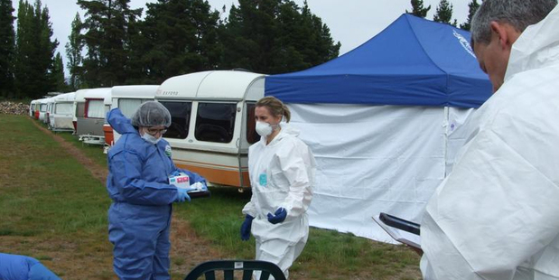 Environmental Science and Research scientist Glenys Knight, Detective Lisa Watt, of Queenstown, and Detective Dean Schroder, of Cromwell at the scene of a body find in Cromwell. Photo / Lynda Van Kempen