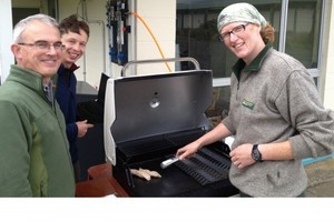 DoC staff fire up the hydrogen-powered barbecue. Excess power from wind turbines and solar panels was used to produce the hydrogen.