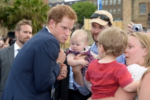 Prince Harry shows his best mad-uncle funny face for a young child in the large crowd greeting him during the International Fleet Review in Sydney. Photo / AP