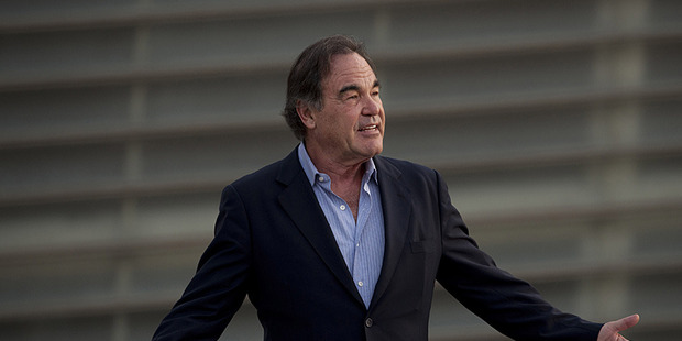 Oliver Stone gestures to photographers during a photocall for the 61st San Sebastian Film Festival. Photo / AP