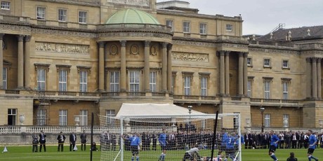 Polytechnic FC (blue) play Civil Service FC in the grounds of Buckingham Palace. Photo / AFP