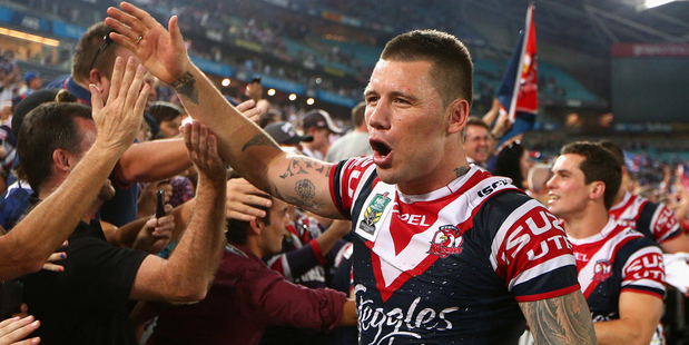 Shaun Kenny-Dowall of the Roosters celebrates with fans after winning the grand final. Photo / Getty Images