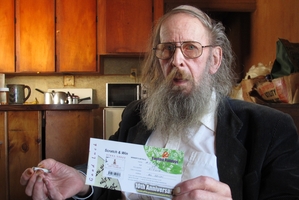 SCAMMED: Mike Howard with the scratch-and-win ticket claiming he had won US$170,000. PHOTO / PETER DE GRAAF
