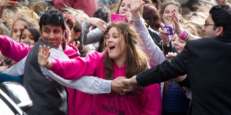 Fans fight to get a view of the boy band outside the Langham Hotel yesterday. Photo / Richard Robinson