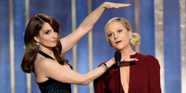Tina Fey and Amy Poehler will host the Golden Globe Awards for the next two years. Photo / AP