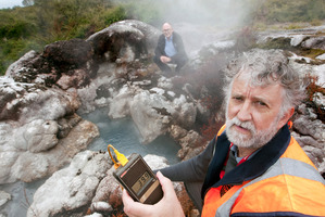 111013bf3 GNS Science volcanologist Brad Scott, front, measures the temperature of the previously dormant Papakura geyser in the Whakarewarewa valley. Pictured behind is Te Puia chief executive Tim C