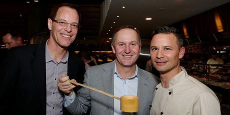 John Key does the honours at Masu, with Simon Dallow and owner Nic Watt.