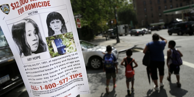 This file photo shows a poster soliciting information regarding the unidentified body near the site where the body was found in New York. Photo / AP
