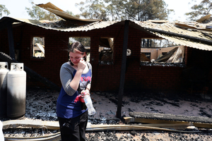 A distraught Stephanie Burton, 16, walks through the remains of a property in the Blue Mountains. Photo / Renee Nowytarger