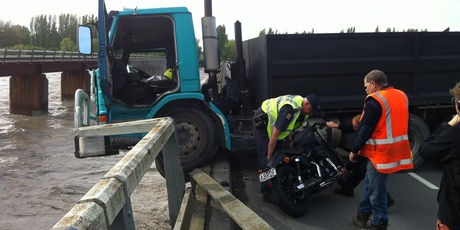 A close call for the driver of this motorcycle who ended up clinging to a tree in the flooded Waimakariri River this morning. Photo / APNZ
