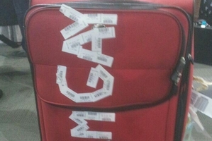 The passenger found his luggage on the carousel defaced.