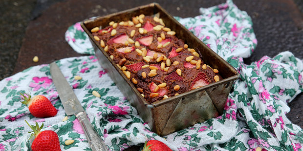Moist date and almond cake topped with strawberries and pine nuts. Photo / Eleanor Ozich