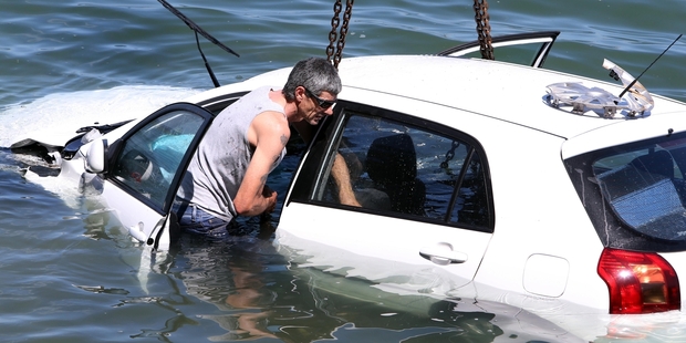 Kym Gyton rescued an elderly woman after she drove into the Whangarei Harbour. At right, the car is recovered. Photo / John Stone
