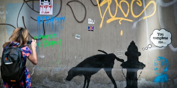 Oct 4 file photo of graffiti by the secretive British artist Banksy, featuring a dog and a fire hydrant. Photo / AP