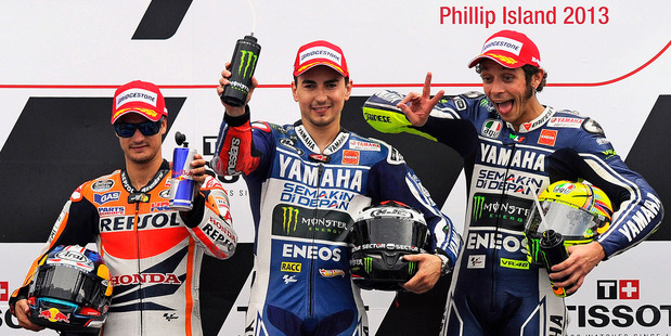 MotoGP riders, from left, Dani Pedrosa of Spain, Jorge Lorenzo of Spain and Valentino Rossi of Italy pose on the winners podium after the Australian motorcycle Grand Prix in Phillip Island. Photo / AP