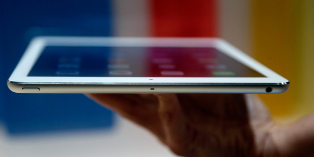 An Apple employee holds up the new iPad Air in San Francisco.