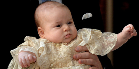 Britain's Prince George is held by his father Prince William as they arrive at Chapel Royal in St James's Palace in London, for the christening of the three month-old.