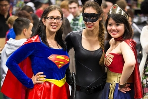 Super heroes, from left, Sabina Giurgiu, Sian Camp and Adelie Tan rub shoulders with fellow fans at the Armageddon Expo. Photo / Greg Bowker
