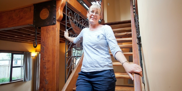 Shereen Bell (pictured) and husband Tim are selling Treehaven, the home built using wood salvaged from the historic St George's Anglican Church Gate Pa. Photo / Andrew Warner