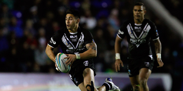 Shaun Johnson (L) of New Zealand in action during the Rugby League World Cup Group B match between New Zealand and Samoa at the Halliwell Jones Stadium on October 27. Photo / Paul Thomas.