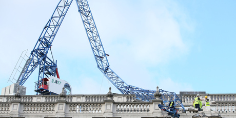 Engineers look at the damage as a crane working on redevelopment at the Cabinet Office in Whitehall, near to Downing Street in London, was brought down by high winds. Photo / AP