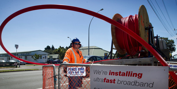 Workman Josh Brown feeds ducting for the ultrafast broadband network in Tauranga. The Commerce Commission is due to reveal a final decision on broadband pricing this week. Photo / NZ Herald