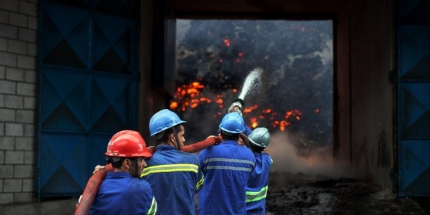 Firefighters attempt to extinguish a fire in a warehouse with sugar at the port of Santos, near Sao Paulo, Brazil. Photo / AFP