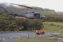 An Air Force helicopter takes off in the attempts to rescue two climbers stuck on Mt Taranaki for two nights. Photo / Jim Tucker