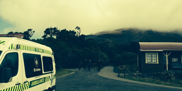 An ambulance waits at the North Egmont visitor centre, a third the way up Mt Taranaki. The search base at Tahurangi Hut is beside the communications tower seen at top centre. Photo / Jim Tucker