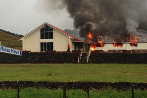 FLAMES: Smoke pours from Mokau Marae. PHOTO/LEANNE YENDALL-ROSS