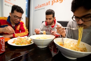 Mosab Askar (left), with brother Abdullah and Khalid Alisha, says he eats more in NZ. Photo / Richard Robinson