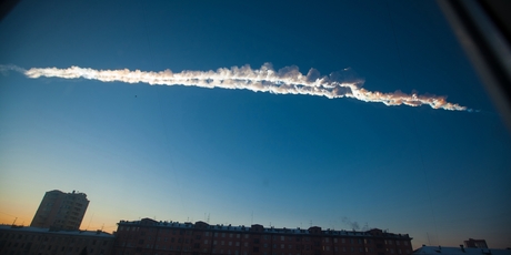 Tests on the meteor fragments (below) after the explosion in the skies over the Siberian city of Chelyabinsk (above) in February show the rock was about the same age as the Earth. Photo / AP