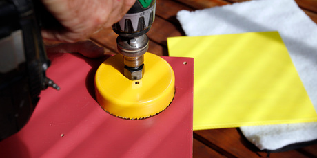 Use hole saw to cut play holes. Photo / Michael Craig