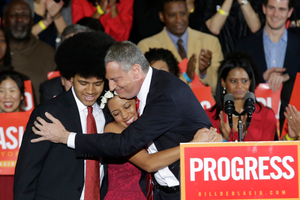 Mayor-elect Bill de Blasio embraces his son Dante, left, and daughter Chiara, center, after he was elected the first Democratic mayor of New York City in 20 years.