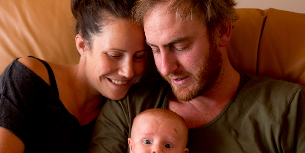 Rob Brown and Nina Bartlett with their young son George Brown, who all survived a speeding car that crashed into their bedroom of their house in Mt Eden.